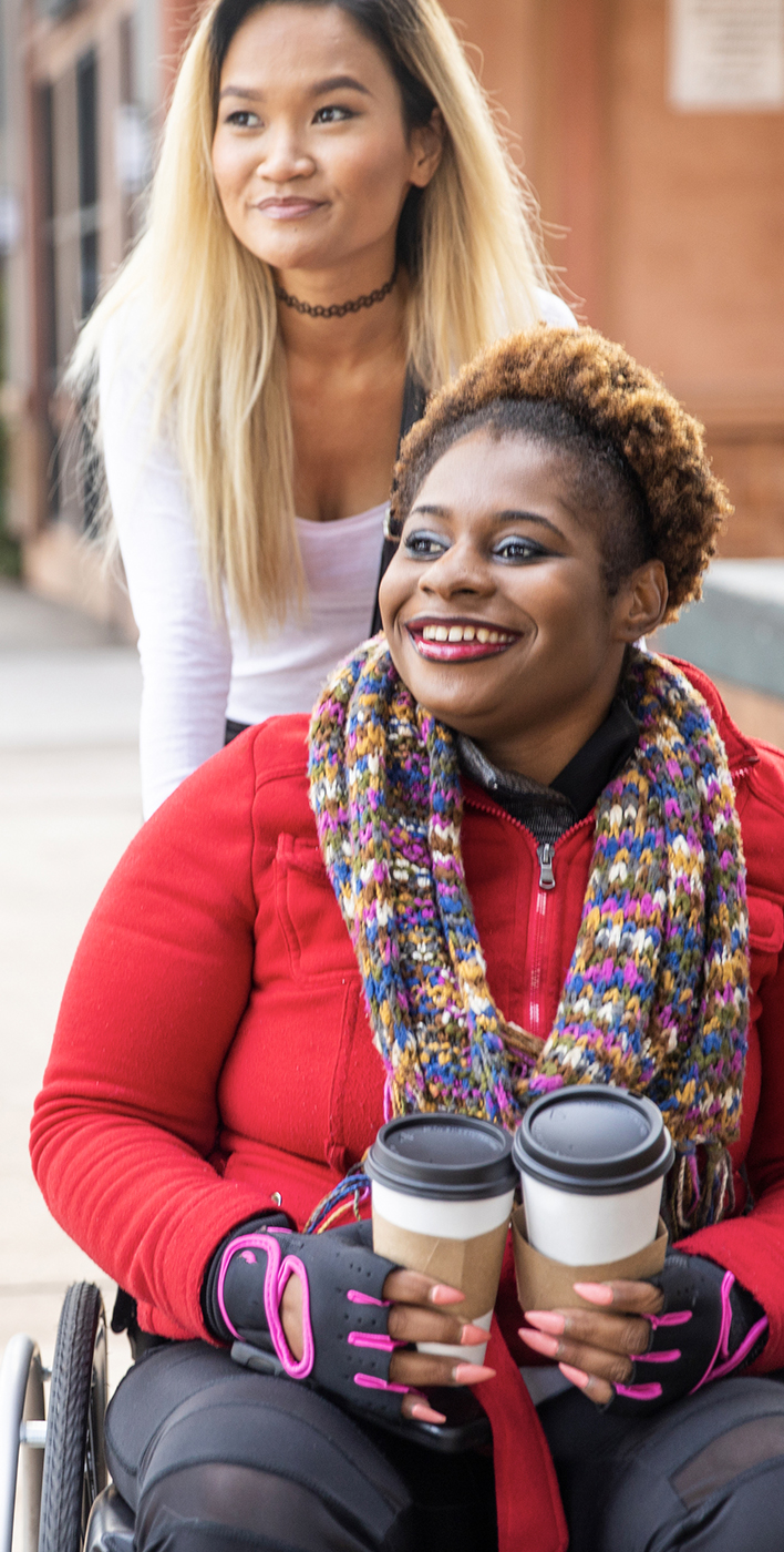 African American female in a wheelchair going for a stroll friend.