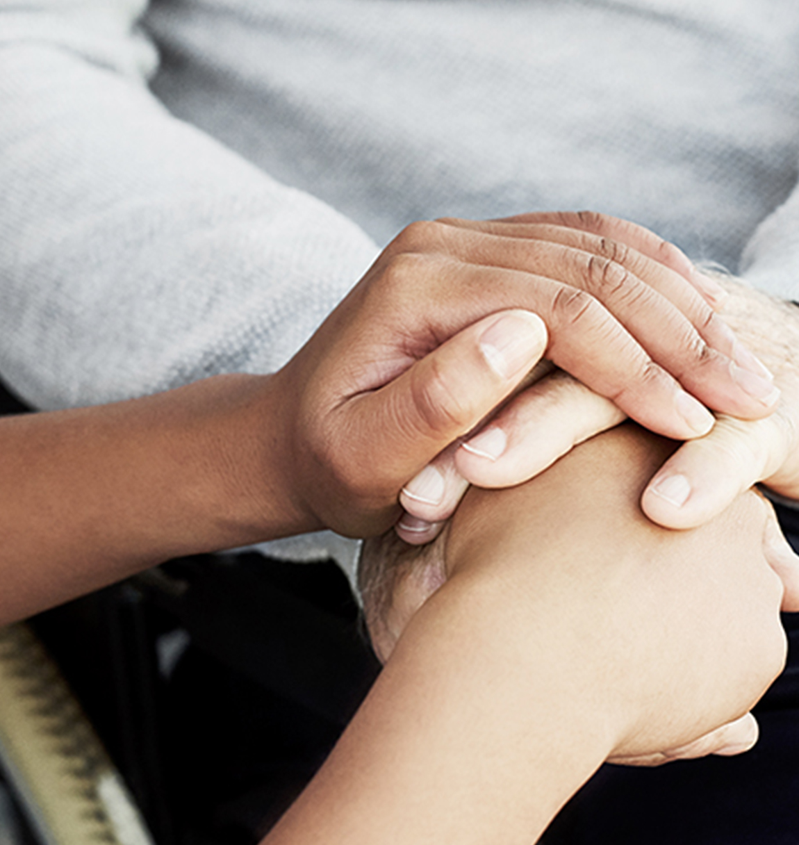 A close-up shot of holding hands.